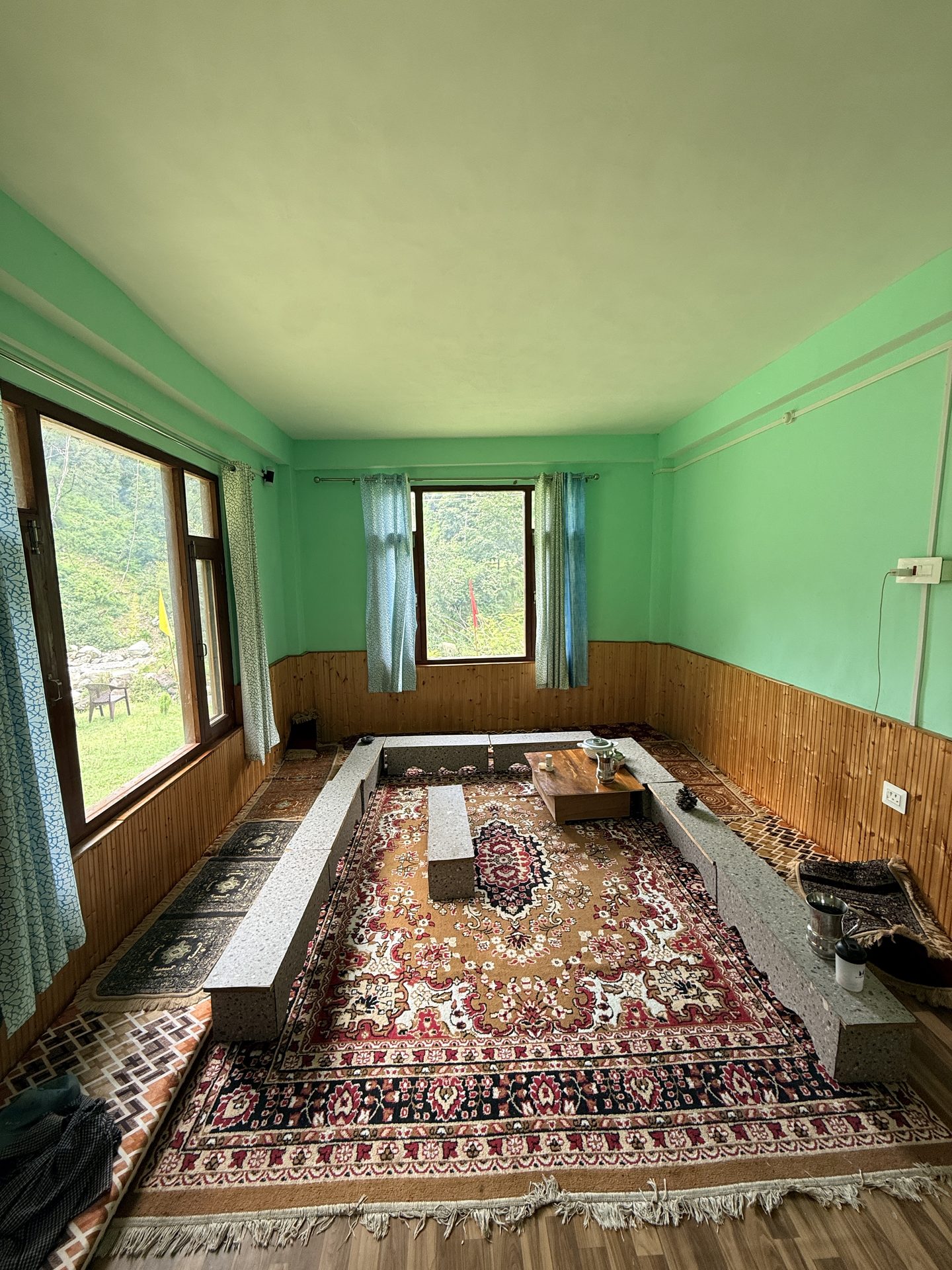Wood-panelled living and dining room at River Edge Home Stay